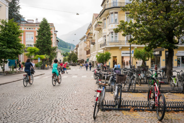 Downtown Merano with bicycles and cobblestone streets.